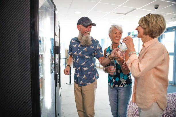 Seniors Getting a Drink from a Vending Machine