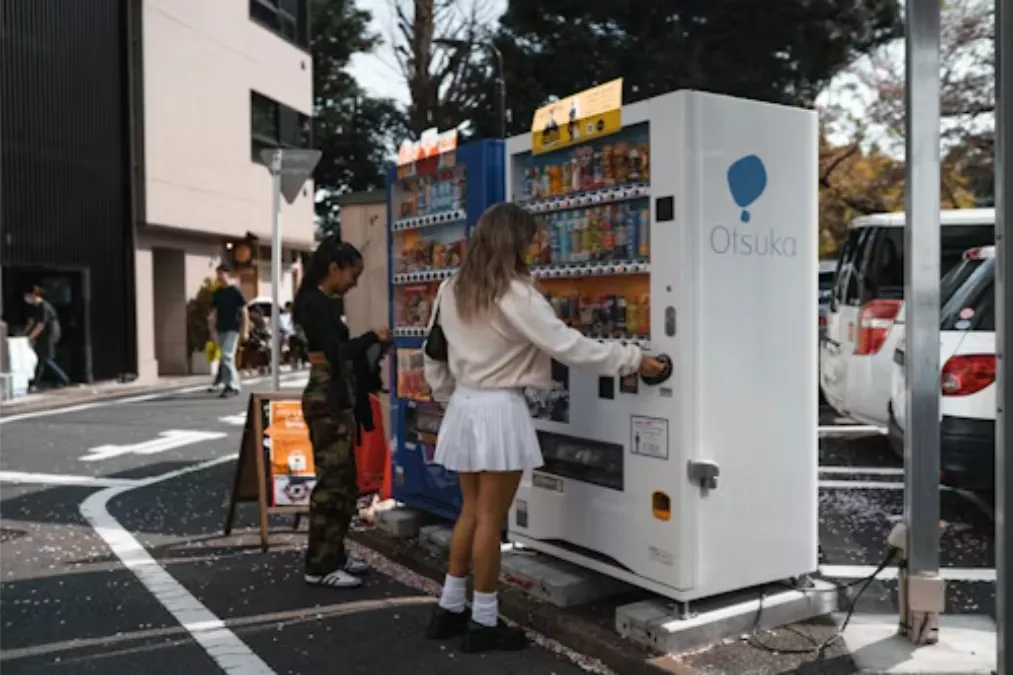 a-woman-standing-next-to-a-vending-machine_1779078102