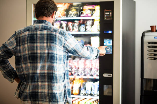 rear-view-of-man-using-vending-machine